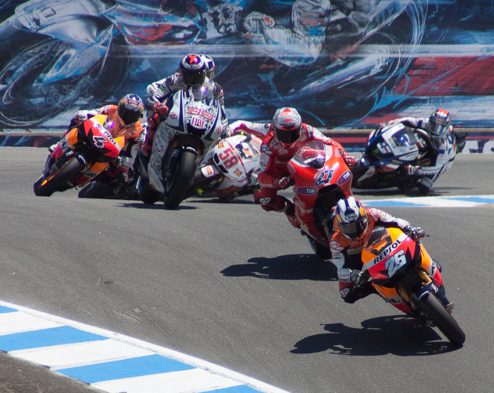 Pedrosa leads the pack at the Corkscrew, first lap, while Spies rides two-up with Lorenzo.  :-)